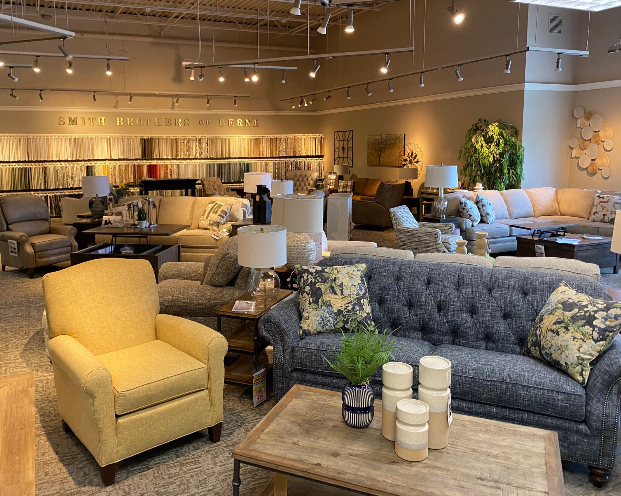 Modern living room arranged with a comfortable sofa, accent table, and coordinated wooden furniture